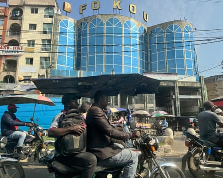 People ride on motorbikes on a bike