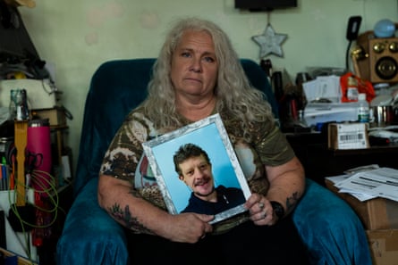 Elaine Grady holding a framed photograph of Peter Giesel.