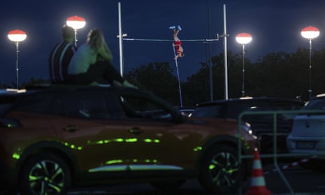 The German pole vaulter Karsten Dilla jumps at the “psd Flight Night” on Friday in Duesseldorf, Germany. Spectators can watch the competition from their cars.