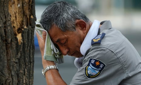 A security guard wipes sweat from his forehead in Beijing, China, on 3 July 2023.