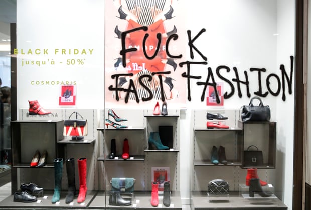 French activists protest the annual Black Friday shopping frenzy in Paris. The slogan fuck fast fashion has been written on a shop window