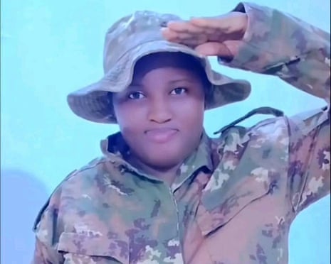 Mariam Cissé salutes to the camera while wearing combat gear