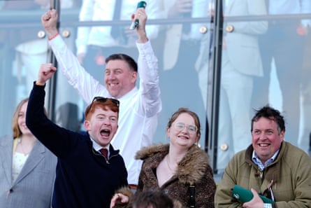 Racegoers celebrate a winner at Aintree on Thursday.