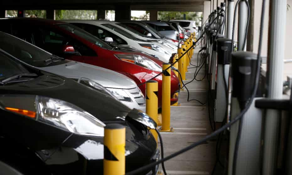Electric cars sit charging in a parking garage at the University of California, Irvine