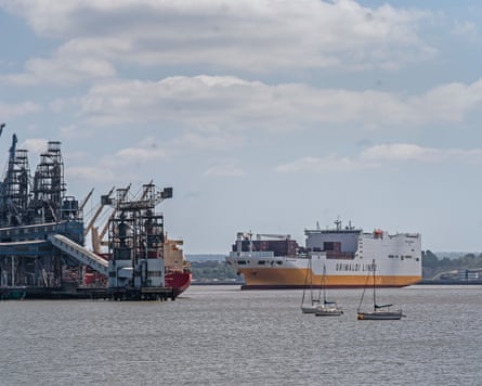 A ferry and boats next to a docking area on the Thames