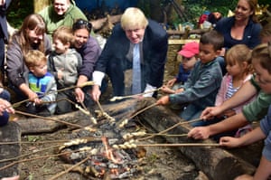 London mayor Boris Johnson cooks damper bread with children and volunteers at the Wide Horizons Centre in Shooters Hill, south-east London