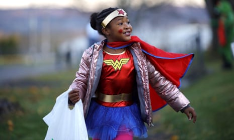 Wonder Woman, also known as Timya Garett, seven, trick-or-treats from house to house on New Hampshire Avenue on 2 November 2019.