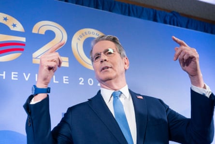 Bessent raises his hands while speaking to reporters