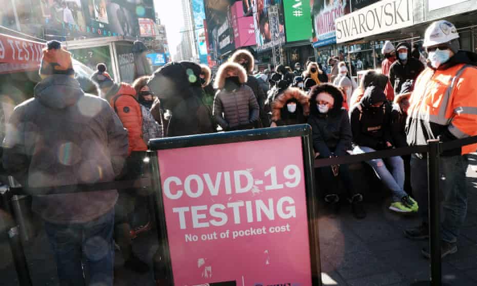 People wait in long lines in Times Square to get tested for Covid-19 on Monday in New York.