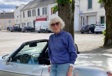 Susan Laborde smiles as she leans back against her Fiat Barchetta