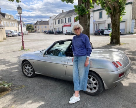Susan Laborde smiles as she leans back against her Fiat Barchetta