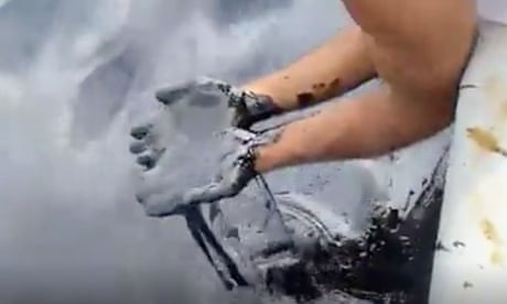The oil-coated hands of fisherman and environmentalist Gary Aboud reveal the gravity of the latest spill in the Gulf of Paria.