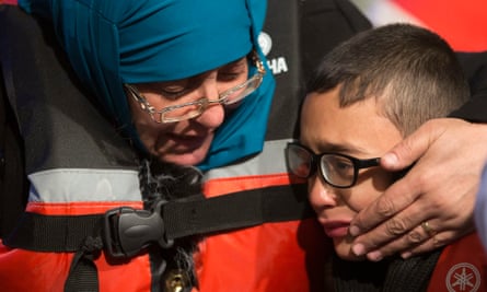 Yusuf, a Syrian refugee, is comforted by his mother Fatma after they were stopped by the Turkish coastguard off Çeşme.