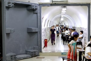 People sitting at tables in a tunnel