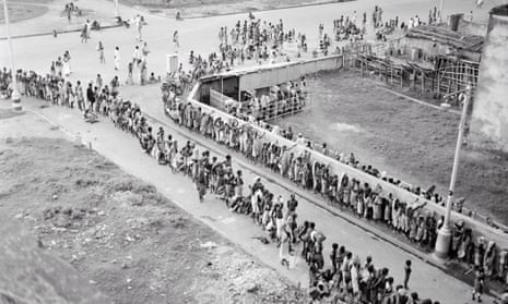 Indian citizens waiting in line at a soup kitchen