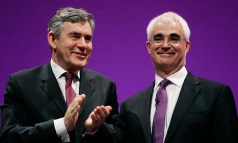 Gordon Brown claps his hands while standing beside Alistair Darling
