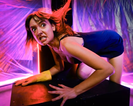woman on stage grimaces menacingly