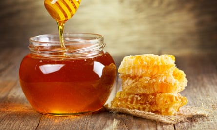 Jar of honey with honeycomb