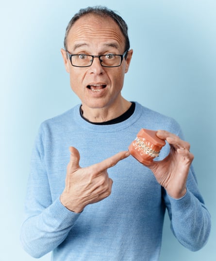 Orthodontist Mike Mew holding a dental cast, photographed at his home in Tunbridge Wells for The Guardian Saturday Magazine, April 2025