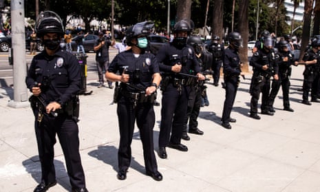 Los Angeles police officers intervene as anti-vaccination demonstrators and counter protesters clash during an anti-vaccination protest organized in front of the City Hall in August 2021.