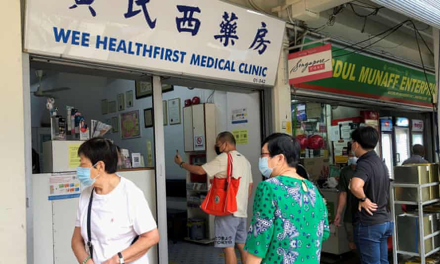 People queue to enquire about Sinovac vaccine at a clinic in Singapore on June 18.