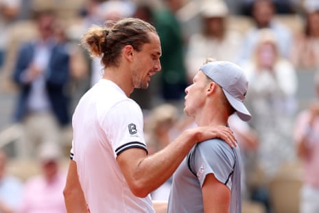 Alexander Zverev of Germany and Jesper De Jong of the Netherlands embrace at the net following their match.