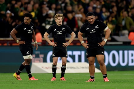New Zealand players look dejected after the final whistle.