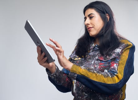 Woman looking sideways at the tablet she’s using