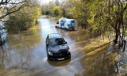 Vehicles stranded in floodwaters of the River Adur, West Sussex, 17 November 2022.