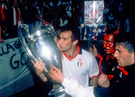 Goalscorer Dejan Savicevic gives the trophy a kiss as the devil looks on.