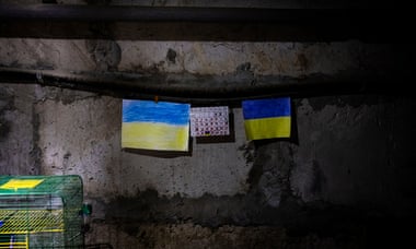 On either side of the calendar are two Ukrainian flags, drawn by a 15-year-old boy who dreamt Ukrainian forces would liberate the village.
