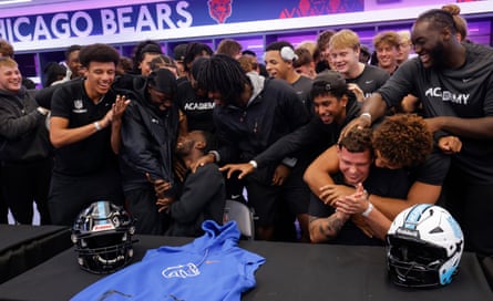 NFL Academy players Arthur De Boachie (left) from Holland and Kevin Bentin from Germany (right) are congratulated by teammates at a commitment ceremony where they announce which US college has given them a scholarship in the home dressing room before the NFL Academy match against De La Salle Spartans from California.