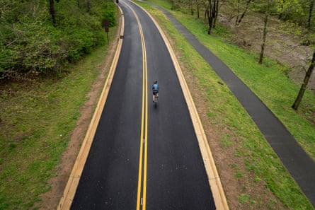 A cyclist rides along Beach Drive in Washington DC in April. The city closed portions of the road to vehicular traffic during the coronavirus outbreak.