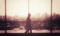 Silhouette of Man Walking Cross the Big Window with Cityscape Landscape in Background<br>S1CAF9 Silhouette of Man Walking Cross the Big Window with Cityscape Landscape in Background