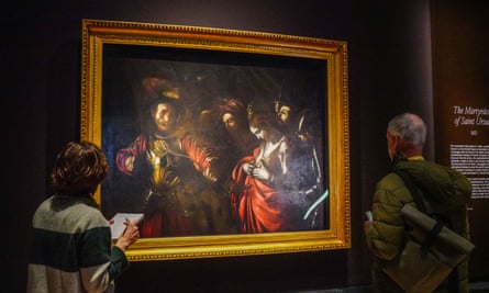 Visitors admire The Martyrdom of Saint Ursula, by Caravaggio, in the National Gallery, London.