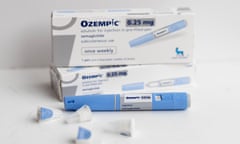 Two boxes of Ozempic stacked on top of eachother against a white background, with a pen and caps in front