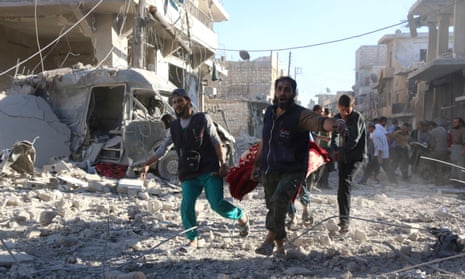Syrian volunteers carry an injured person