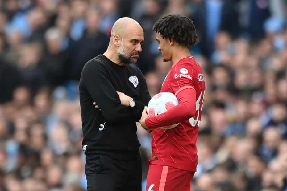 Pep Guardiola shares a joke with Trent Alexander-Arnold of Liverpool during their match. The game ended 2-2 at the Etihad.