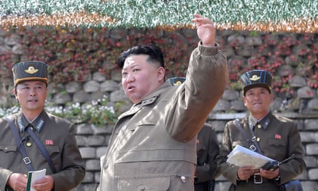 Kim Jong-un stands with men in military uniforms