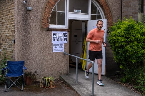 A man jogging out of a polling station in Lewisham.