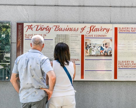 Tourists read a display at the President’s House in Philadelphia entitled ‘The Dirty Business of Slavery’.