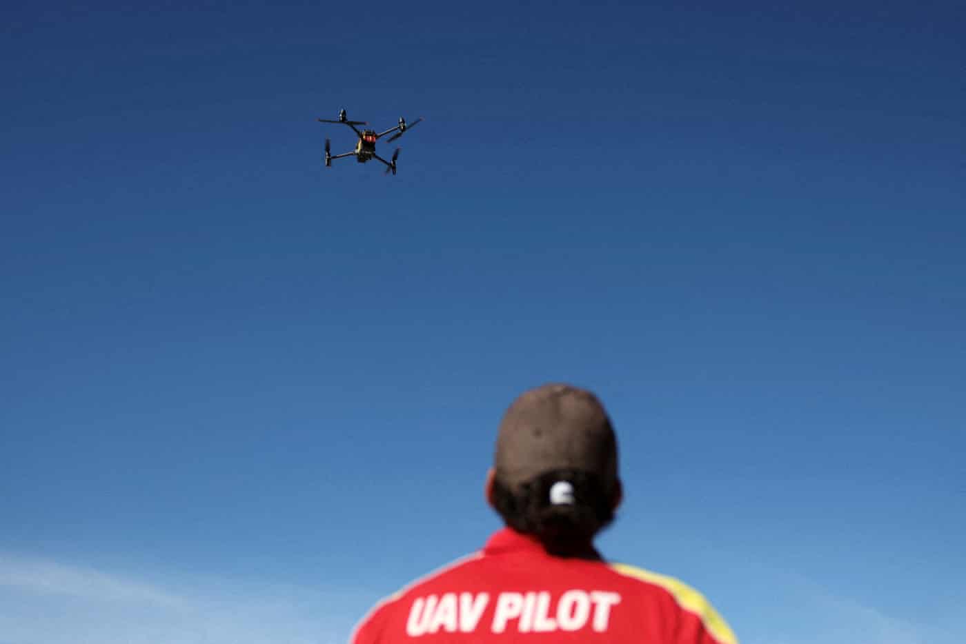 A unmanned aerial vehicle pilot flies a Surf Life Saving shark-spotting drone at Coogee beach in Sydney on 16 June.