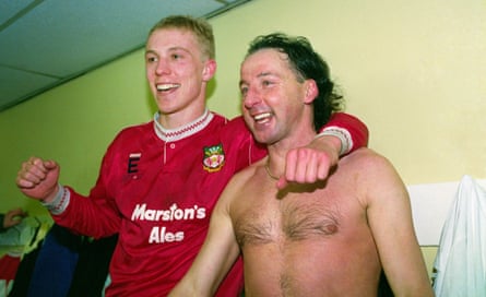 Mickey Thomas with Steve Watkin, scorer of Wrexham’s equaliser against Arsenal, celebrate the 1992 FA Cup third round win in the dressing room