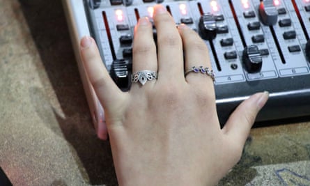A woman’s hands at a studio mixing desk