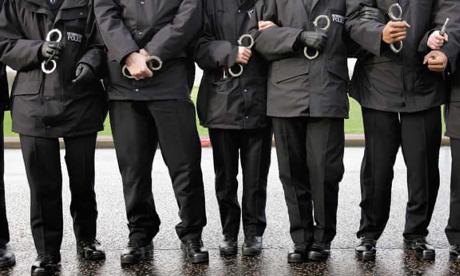 Metropolitan police recruits with handcuffs