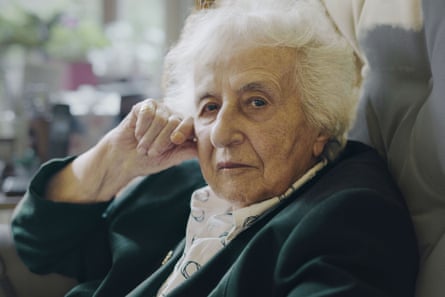 An elderly white woman looks at the viewer
