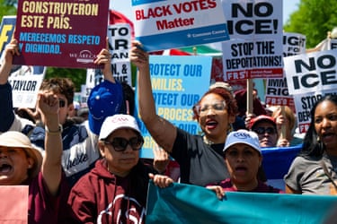 people hold signs outside