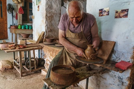Kostas Depastas, traditional clay potter, at his wheel in his workshop in Greece.