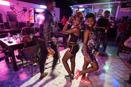 People drink, chat and dance to kizomba music