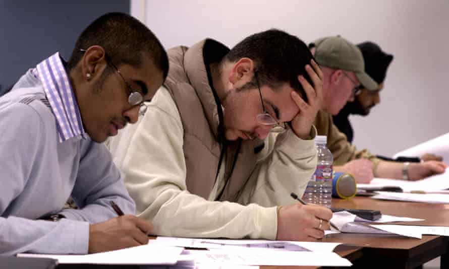 Students in an exam. Labor has promised up to 20,000 extra university places but the Coalition has remained quiet on higher education.